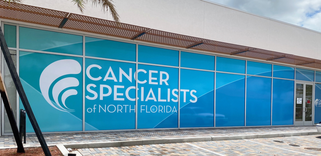 Storefront window display featuring the logo of Cancer Specialists of North Florida.