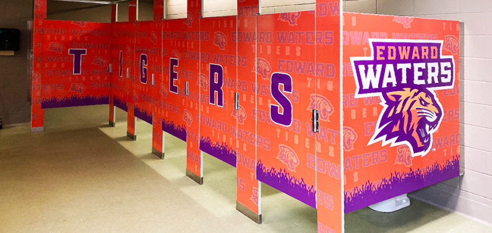 Bathroom stalls featuring the Edward Waters University logo and the word 'TIGERS' in bold letters.
