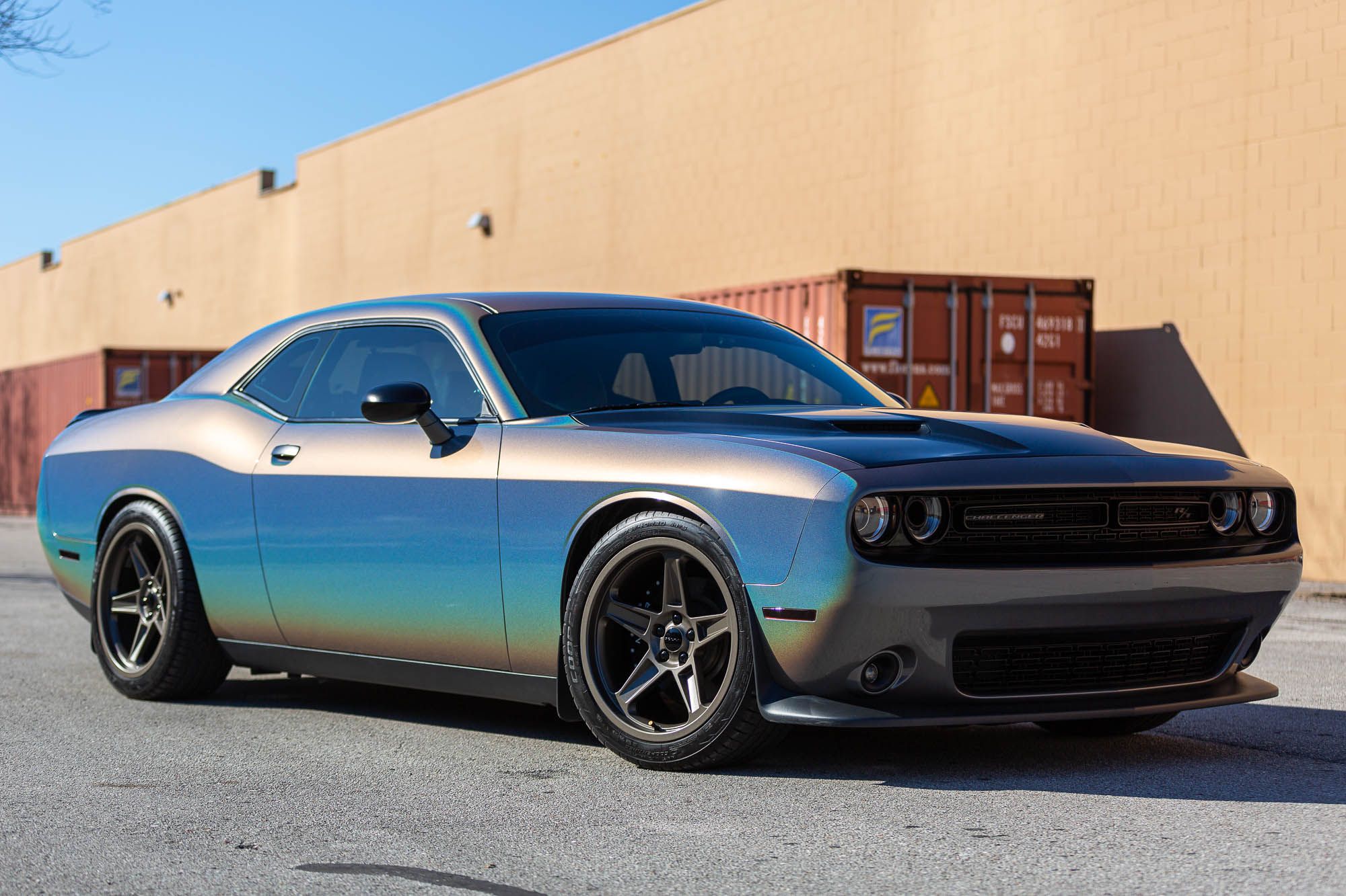 Passenger side of a Dodge Challenger car model wrapped in a color shifting glossy gray chrome colored vinyl car wrap. "Glossy Psychedelic Gray" color shifting Dodge Challenger wrapped by professional car wrap technicians at <a href="http://www.wrapsdirect.com">Wraps Direct</a> in Jacksonville Florida.