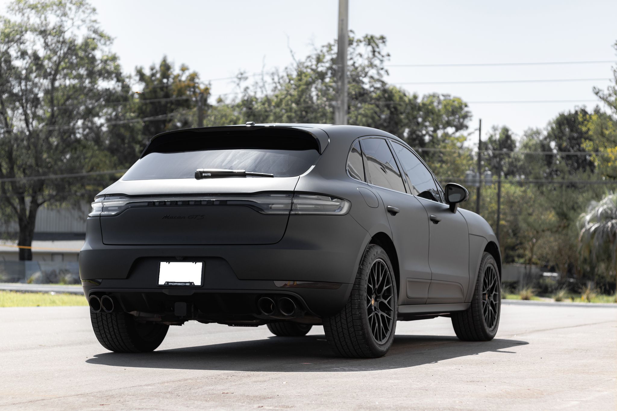 Back of a Porsche SUV car model wrapped in a flat matte black colored vinyl car wrap. Porsche Cayman with a flat "Matte Black" colored vinyl wrap applied by <a href="http://www.wrapsdirect.com">Wraps Direct</a> in Jacksonville Florida.