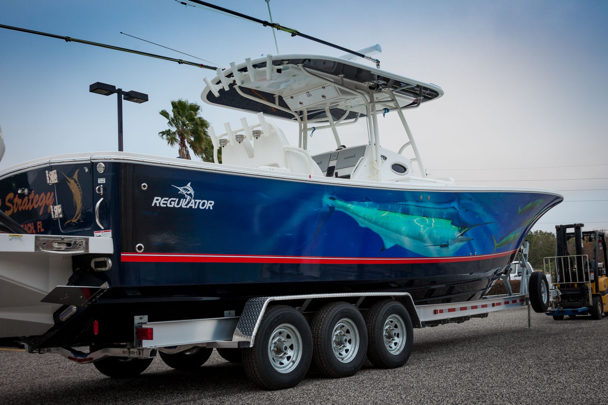 Full image of the professional full vinyl wrap on the "Regulator" fishing boat pulled on a long trailer. Professional "Regulator" design wrapped by Wraps Direct located in Jacksonville, FL