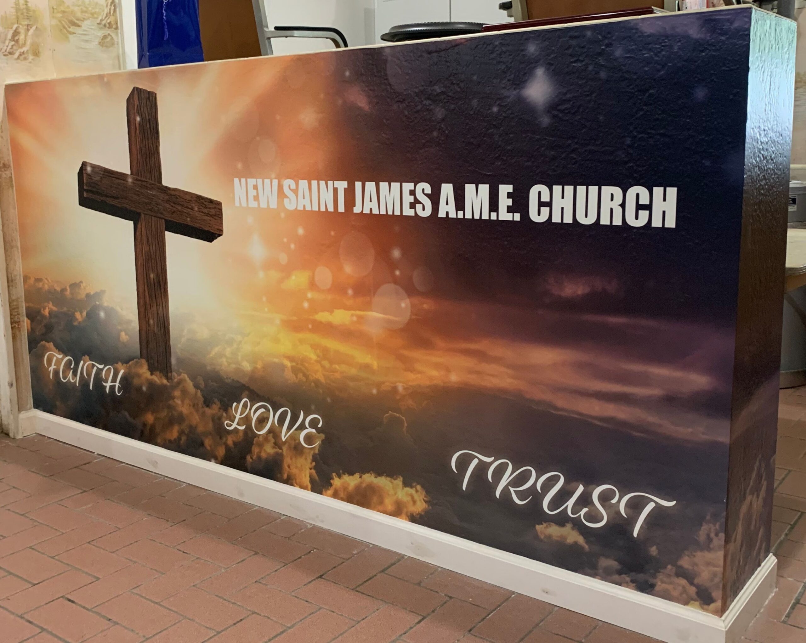 A religious orange and black interior custom vinyl wall wrap depicted on the inside wall of a church that says "Truth Love Trust"