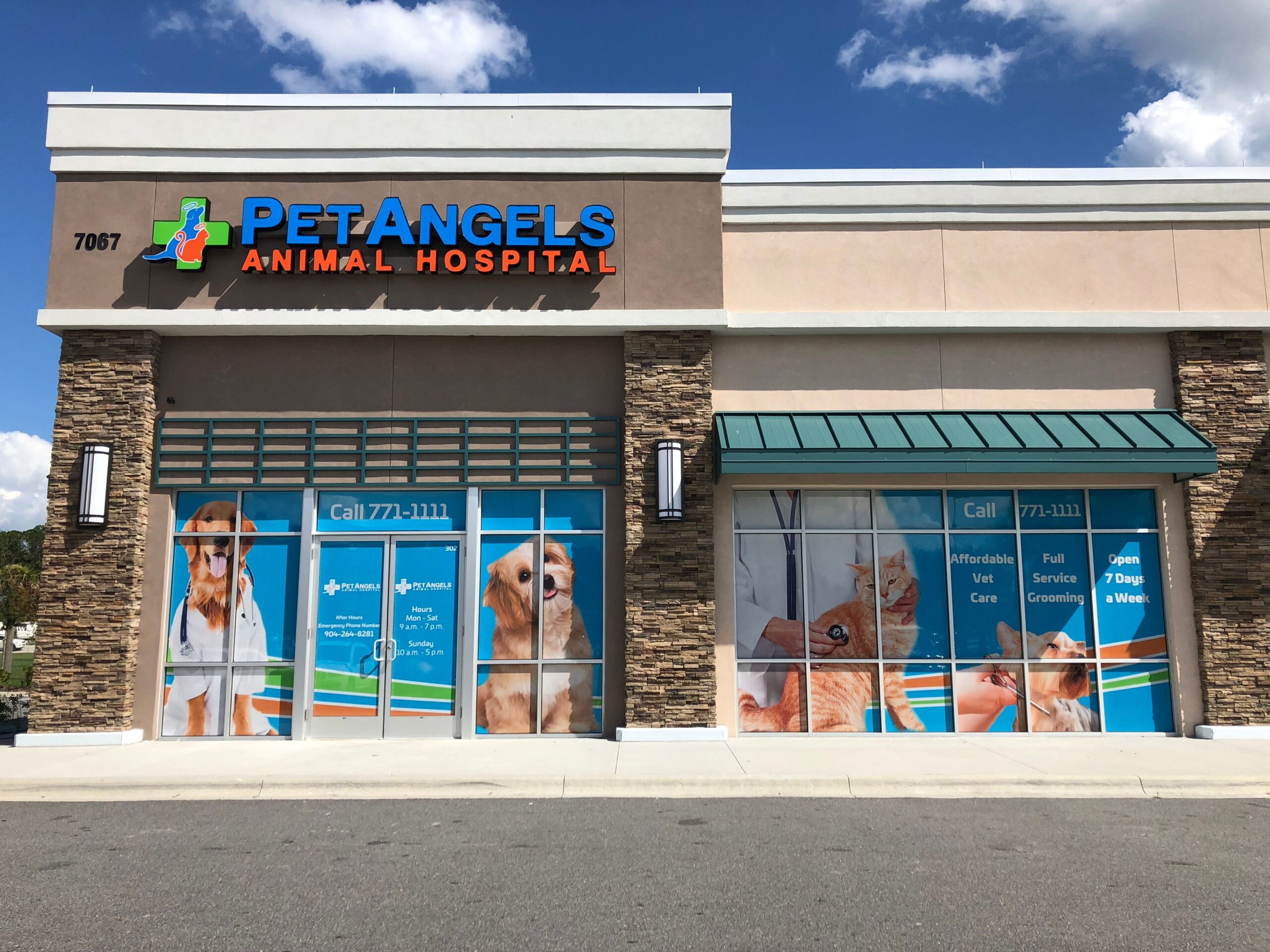 A custom exterior vinyl window wall wrap depicted on the front windows of a pet shop and animal hospital building.