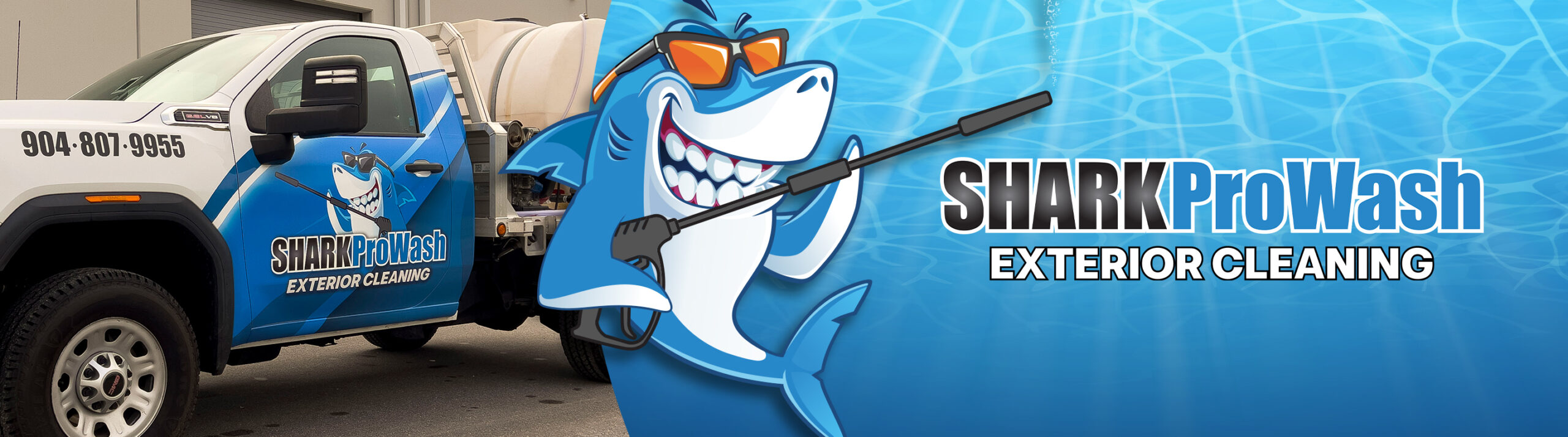 Vehicle with Shark ProWash branding featuring a shark graphic and exterior cleaning equipment.